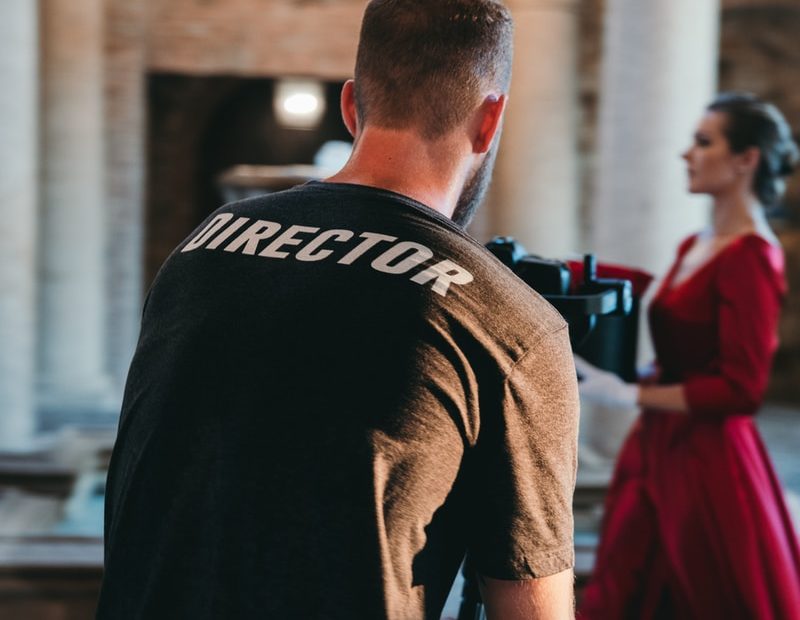 man wearing black Director t-shirt
