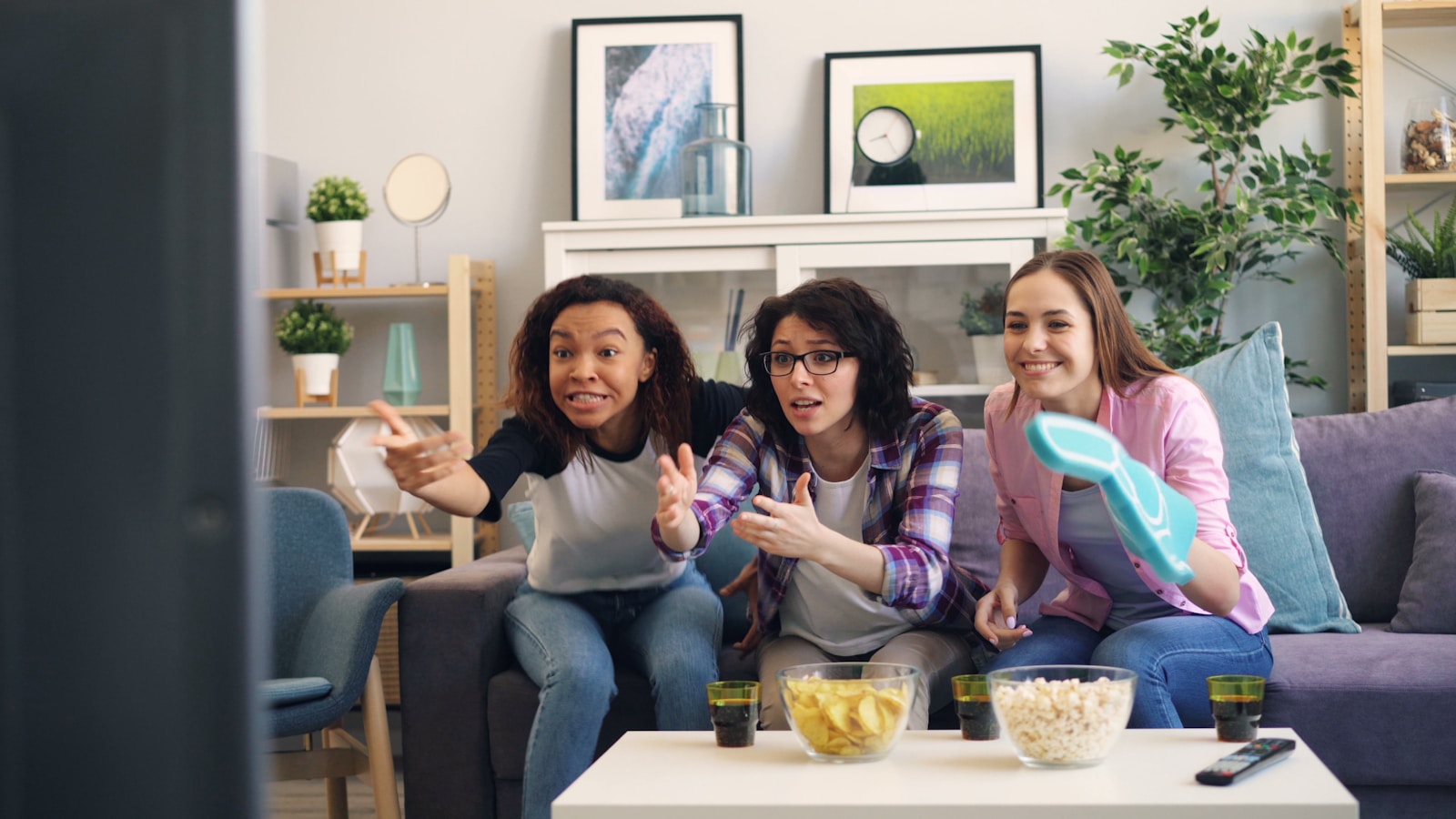 a group of women sitting on top of a couch